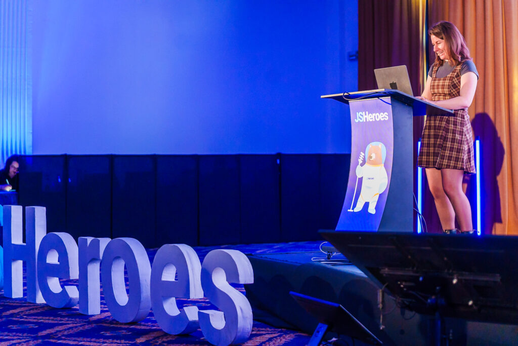 Cyd standing on stage at JS Heroes